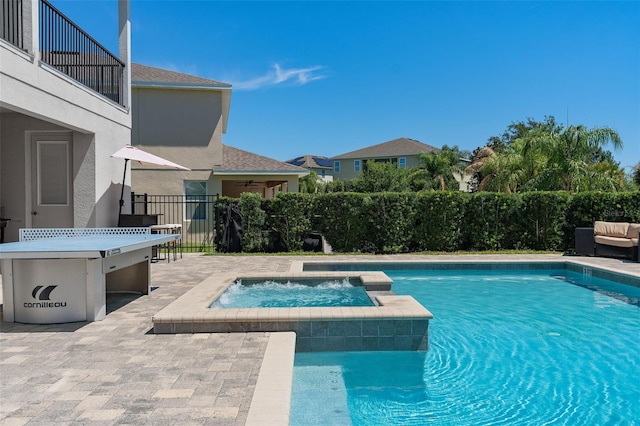 view of pool featuring an in ground hot tub and a patio