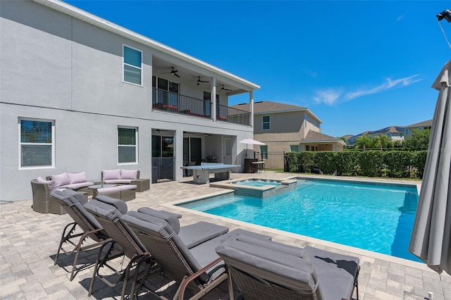 view of pool featuring an in ground hot tub, outdoor lounge area, a patio, and ceiling fan