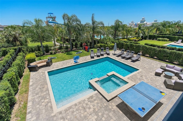 view of swimming pool with an in ground hot tub, a patio, and an outdoor living space