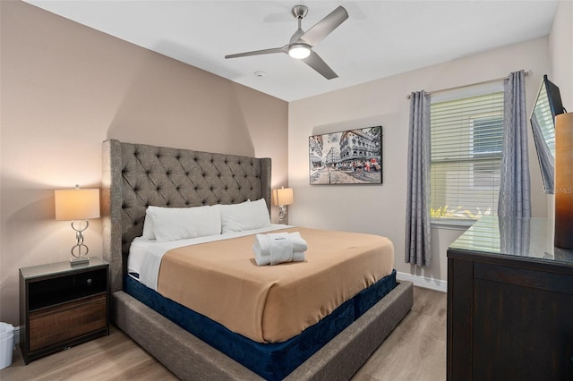 bedroom with light hardwood / wood-style floors and ceiling fan