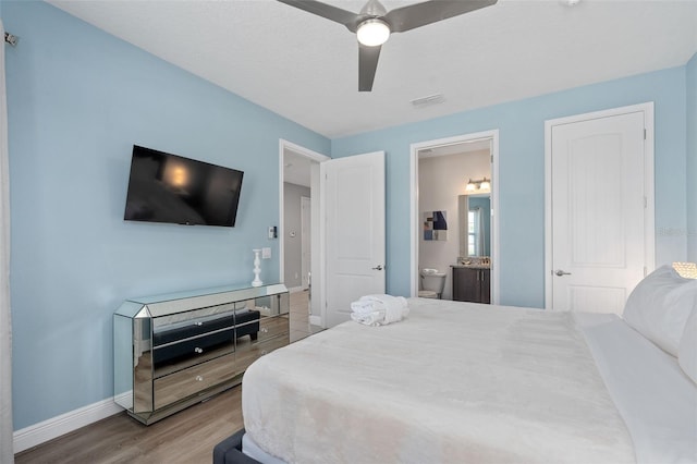 bedroom featuring hardwood / wood-style flooring, ceiling fan, and ensuite bathroom