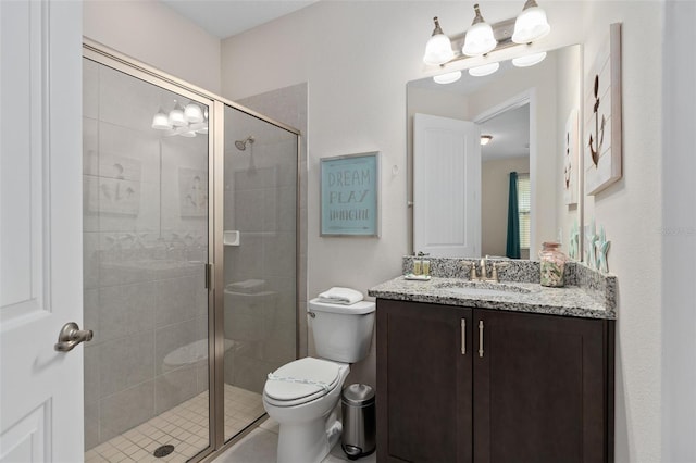 bathroom with vanity, toilet, and an enclosed shower