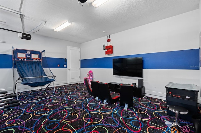 playroom featuring carpet floors and a textured ceiling