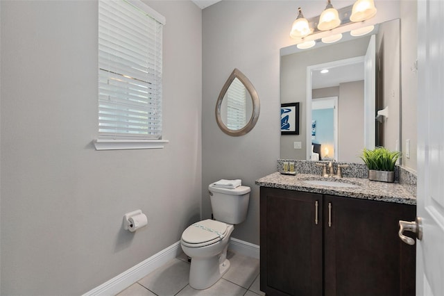 bathroom featuring tile patterned flooring, vanity, and toilet