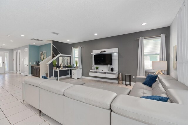 living room with light tile patterned floors and a textured ceiling