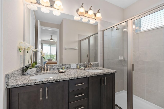 bathroom featuring ceiling fan, a shower with door, and vanity