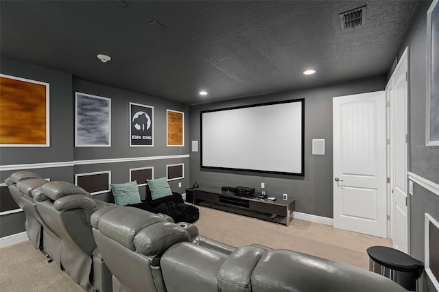 cinema room with light colored carpet and a textured ceiling