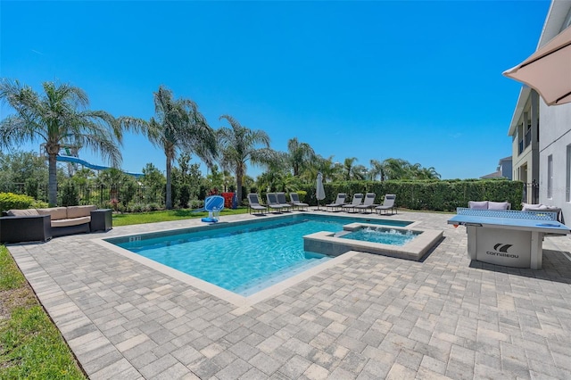 view of swimming pool featuring an in ground hot tub, a patio, and an outdoor hangout area