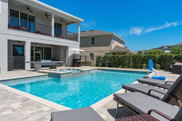 view of swimming pool with an in ground hot tub and a patio