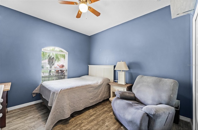 bedroom with ceiling fan, baseboards, and wood finished floors