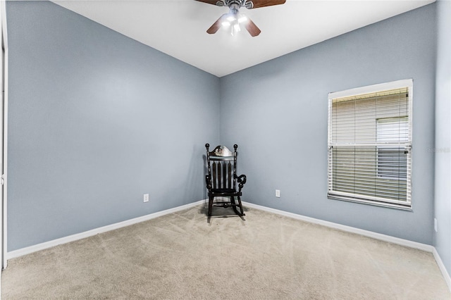 sitting room featuring light carpet, ceiling fan, and baseboards