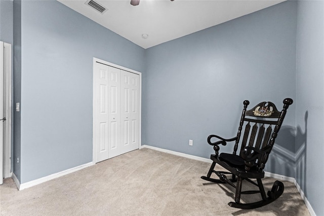 living area featuring light carpet, baseboards, and visible vents