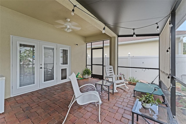 sunroom / solarium featuring ceiling fan