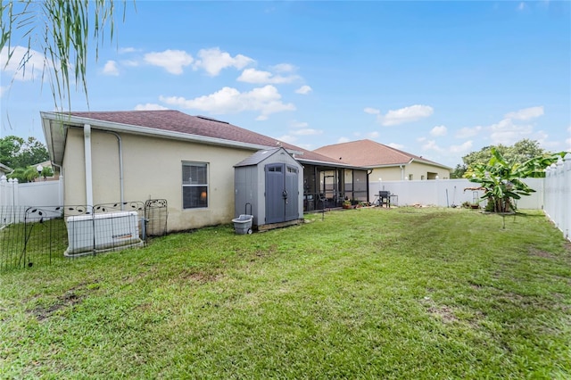 back of house with a storage shed, a lawn, a fenced backyard, an outbuilding, and stucco siding