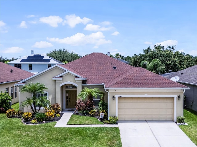 view of front of house featuring roof with shingles, stucco siding, an attached garage, driveway, and a front lawn