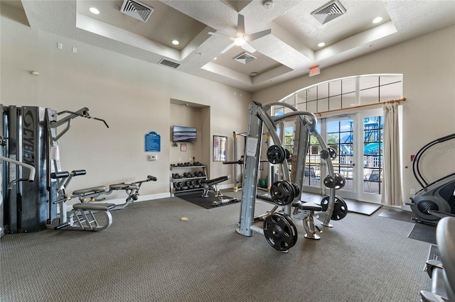 workout area with baseboards, visible vents, and coffered ceiling