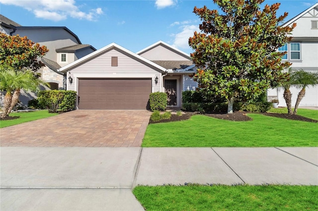 view of front of home featuring a garage and a front lawn