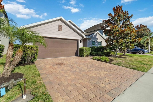 view of front of property with a front yard and a garage