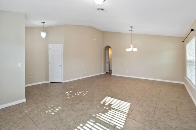 tiled spare room with an inviting chandelier and vaulted ceiling