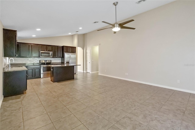 kitchen featuring ceiling fan, a center island, sink, stainless steel appliances, and light tile patterned floors