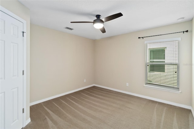 empty room featuring carpet floors and ceiling fan