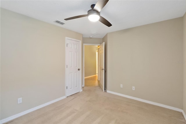 carpeted spare room with ceiling fan