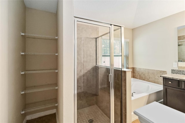 bathroom with vanity and independent shower and bath