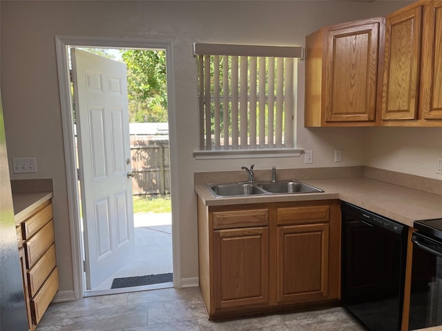 kitchen with dishwasher, sink, and range