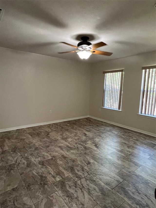 spare room with ceiling fan