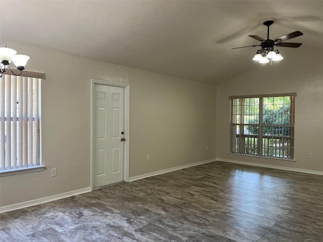 empty room with ceiling fan with notable chandelier and vaulted ceiling