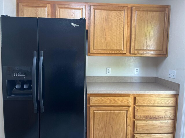 kitchen featuring black fridge with ice dispenser