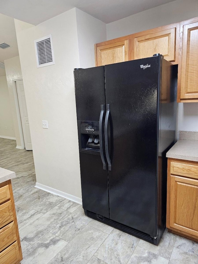 kitchen featuring black fridge with ice dispenser