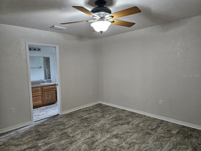 spare room with ceiling fan and sink