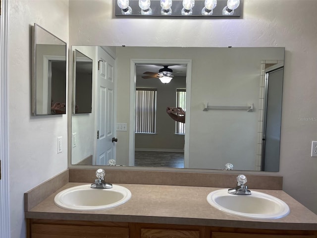 bathroom with ceiling fan, a shower with door, and vanity