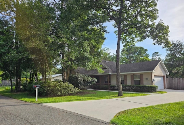 ranch-style house featuring a front lawn and a garage