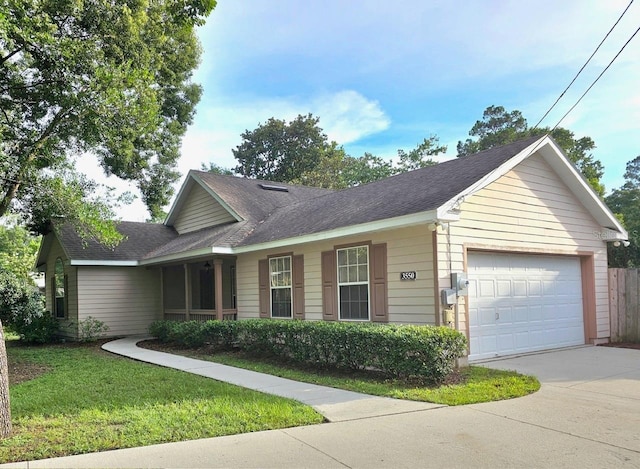 ranch-style home with a garage and a front lawn