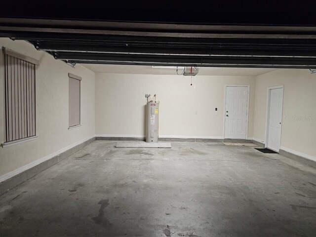 garage with electric water heater and a garage door opener