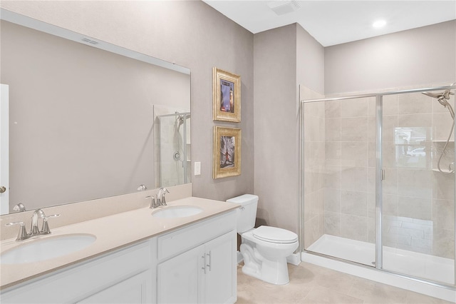 bathroom with walk in shower, tile flooring, toilet, and double sink vanity