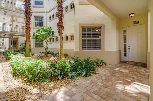 entrance to property with stucco siding