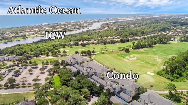 birds eye view of property featuring golf course view, a water view, and a residential view