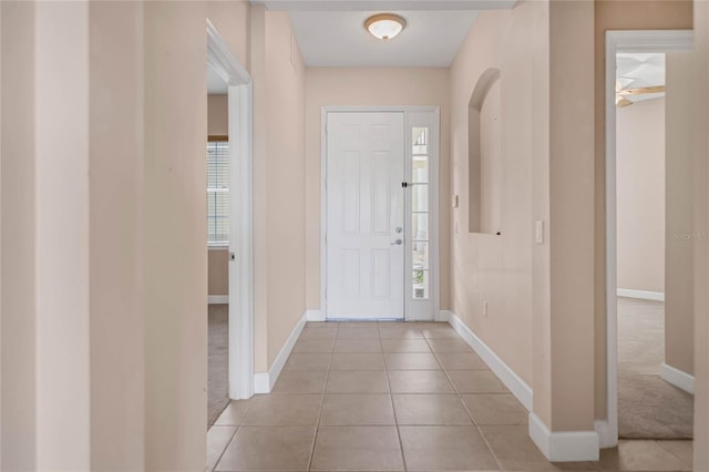 foyer entrance with baseboards and light tile patterned flooring