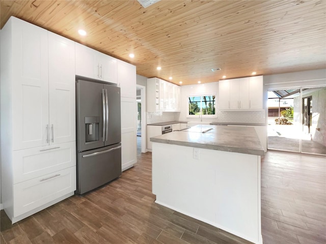 kitchen with white cabinets, a kitchen island, stainless steel refrigerator with ice dispenser, and a wealth of natural light