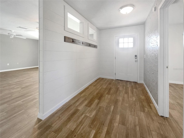 entryway with hardwood / wood-style floors and ceiling fan