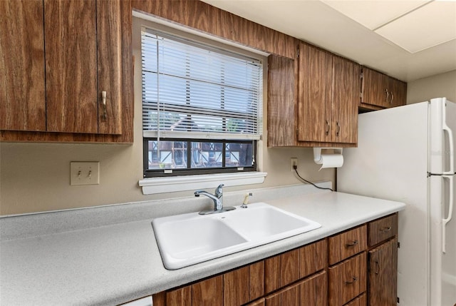 kitchen with sink and white fridge