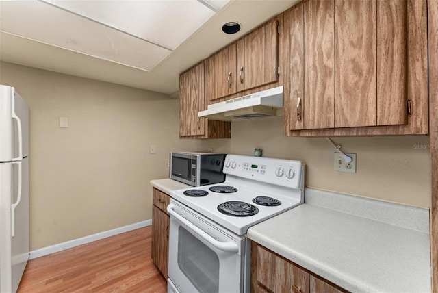 kitchen featuring light hardwood / wood-style floors and white appliances