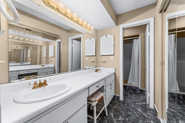 bathroom with a shower with shower curtain and vanity