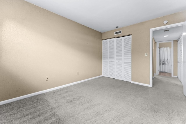 unfurnished bedroom featuring carpet flooring and a closet