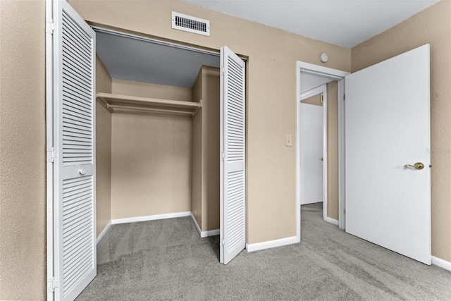 unfurnished bedroom featuring carpet and a closet