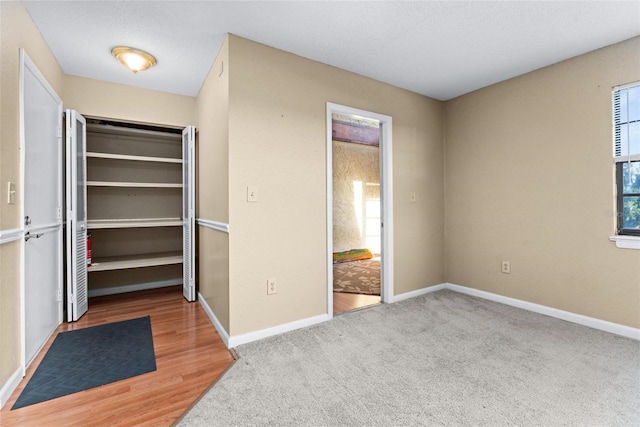 unfurnished bedroom featuring carpet floors and a closet