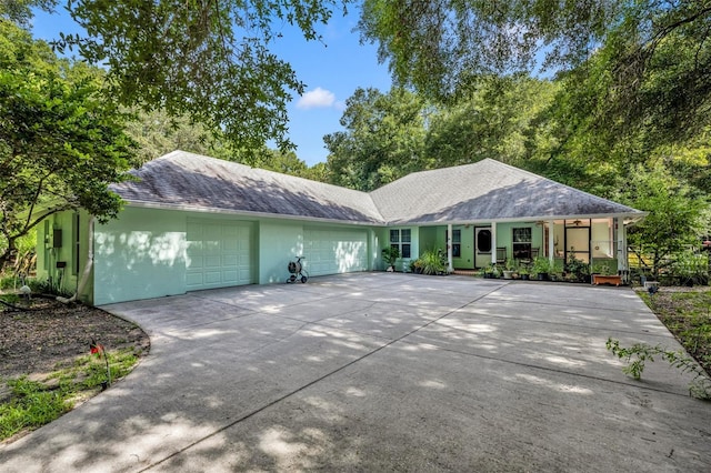 ranch-style home featuring a porch and a garage